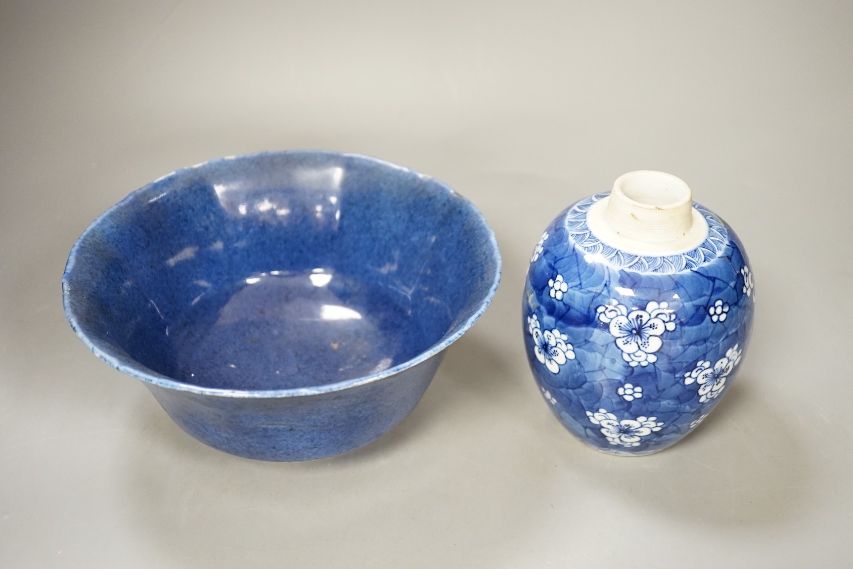 A Chinese powder blue bowl, early 18th century and a Chinese blue and white prunus jar - tallest 13cm